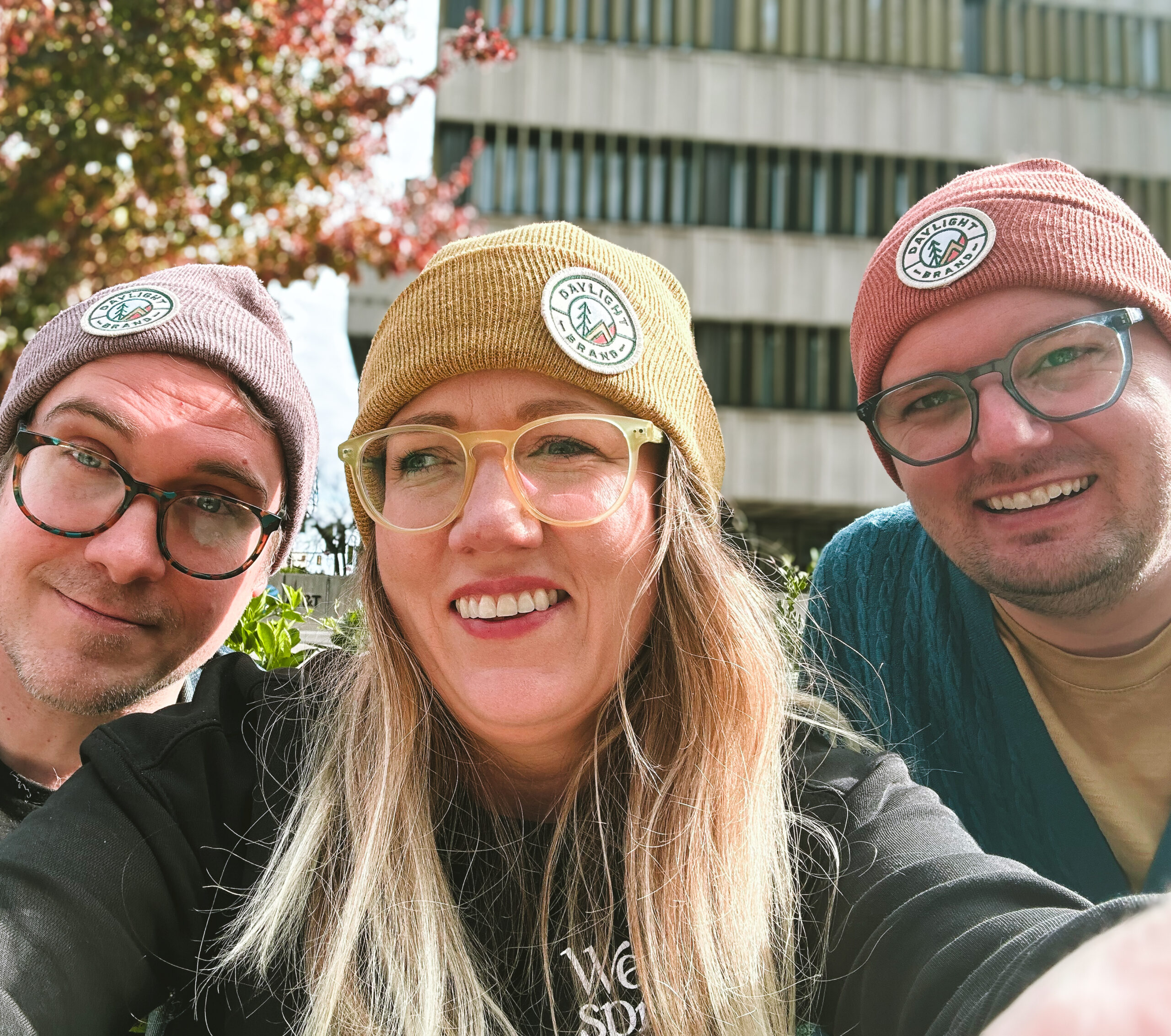 Pair of Ducks creative team (left to right): Justin Gibson, Staci Gibson, and Derek Brouwer wearing Daylight Brand knit hats
